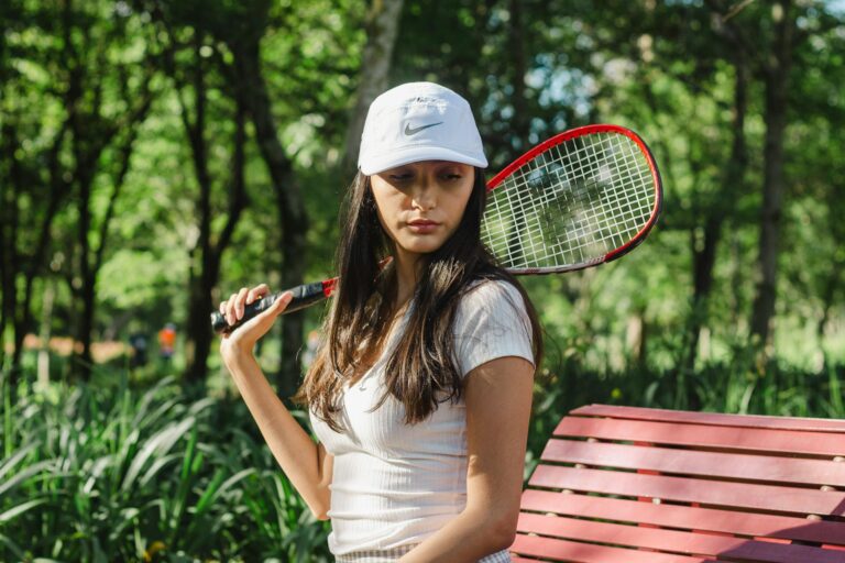 Active woman playing tennis confidently outdoors, demonstrating impact-friendly ostomy support