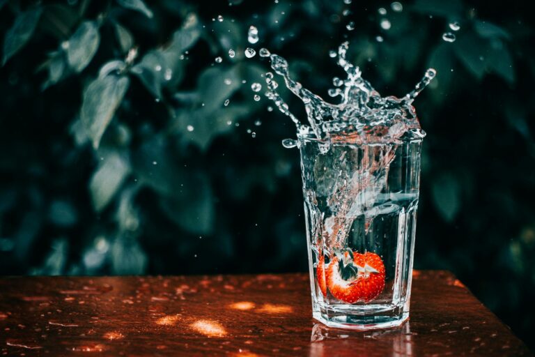 A glass of hydrating water with strawberry, electrolyte hydration concept
