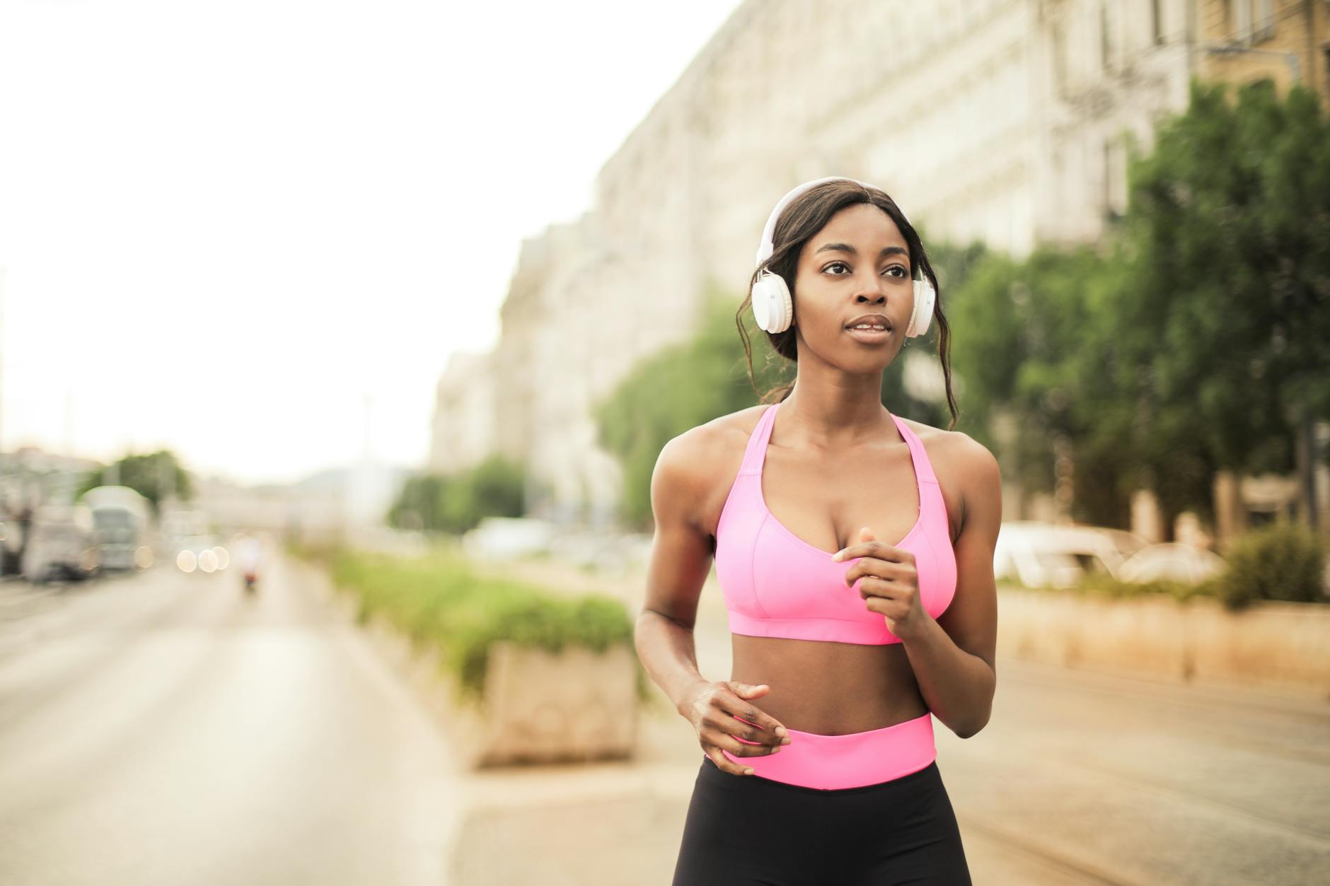 Woman jogging confidently outdoors after solving her ostomy bag leak problem