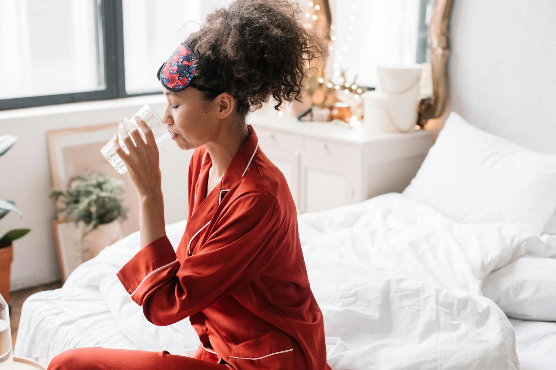 Woman drinking water first thing in the morning to start daily hydration