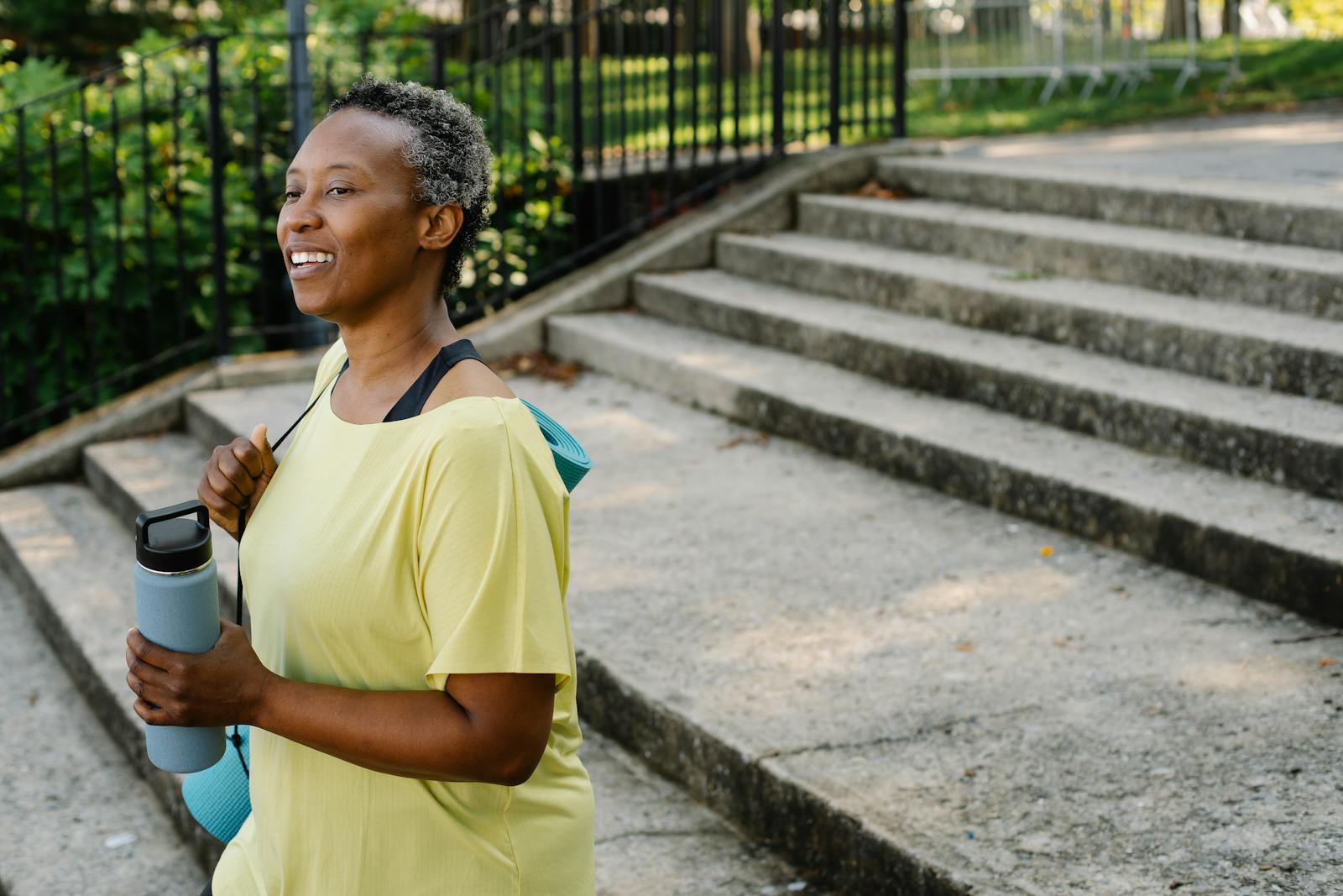 Woman walking outdoors smiling, hopeful and active during ostomy reversal recovery